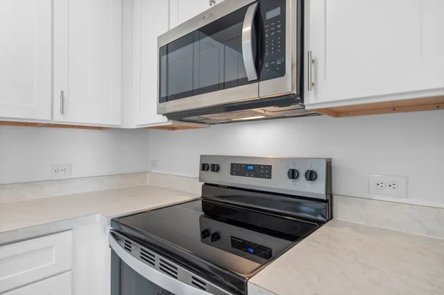 a kitchen with white cabinets