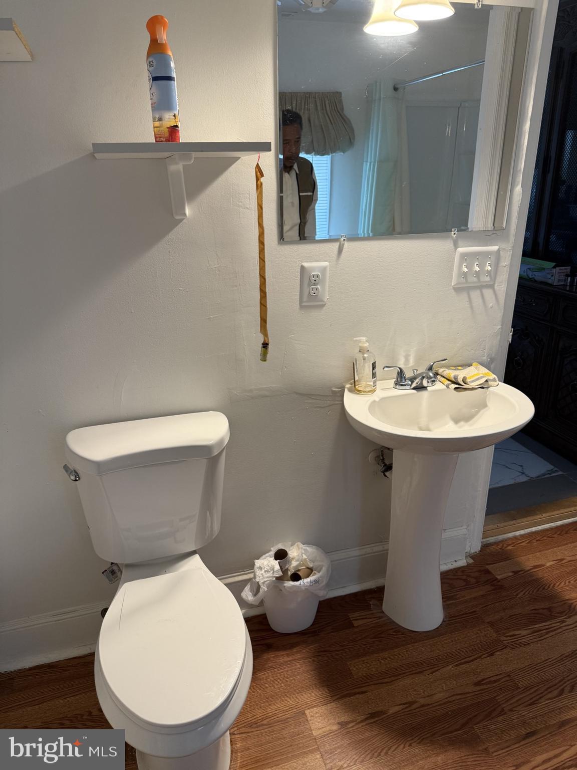 11008 Croom Road Upper Marlboro, MD 20772 - Photo 2 of 3 a bathroom with a toilet sink and mirror