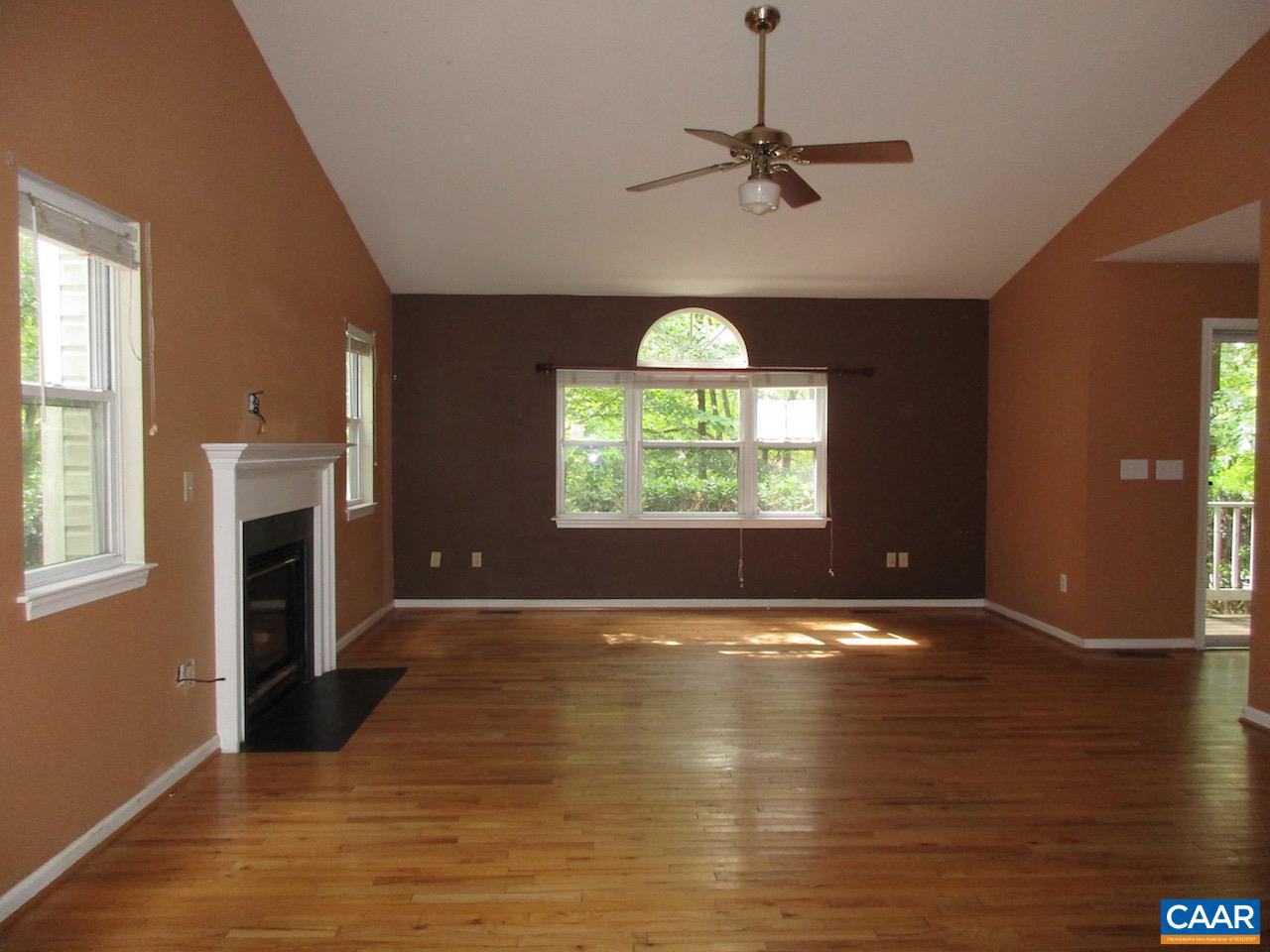 47 Riverside Drive Palmyra, VA 22963 - Photo 4 of 8 an empty room with windows fireplace and wooden floor