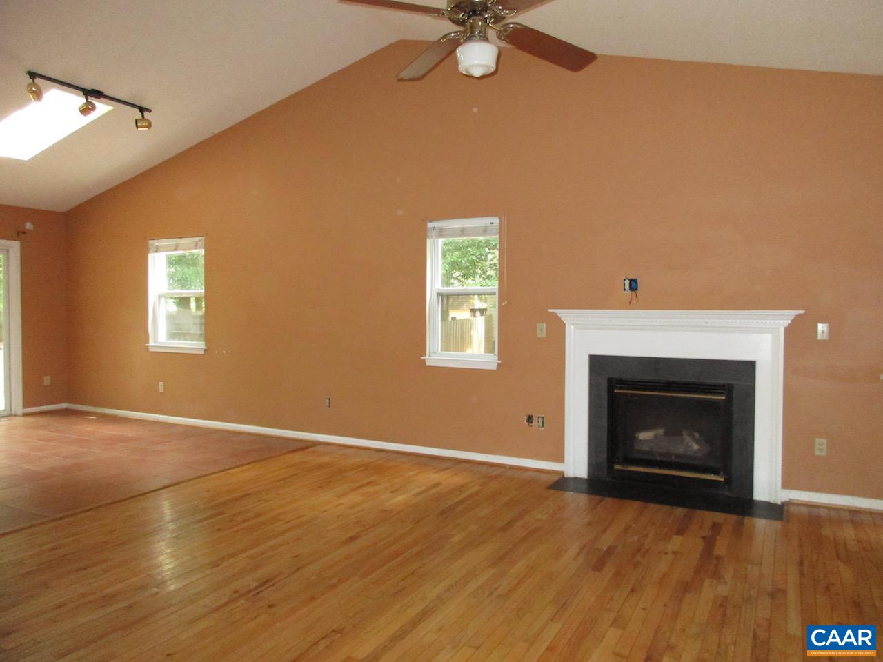47 Riverside Drive Palmyra, VA 22963 - Photo 5 of 8 a view of an empty room with a fireplace and a window