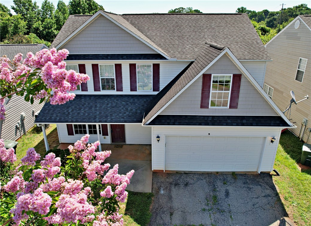 305 North Chestnut Street Seneca, SC 29678 - Photo 2 of 44 Lovely two-story home features a welcoming front entry and attached garage, complemented by vibrant landscaping.