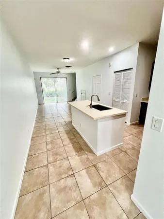 a kitchen with a sink a stove a microwave and cabinets