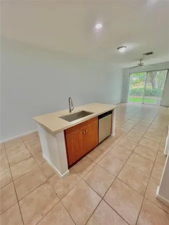 a view of a kitchen with a sink and a window