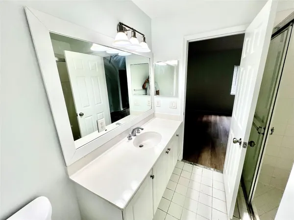 a bathroom with a tub sink and mirror