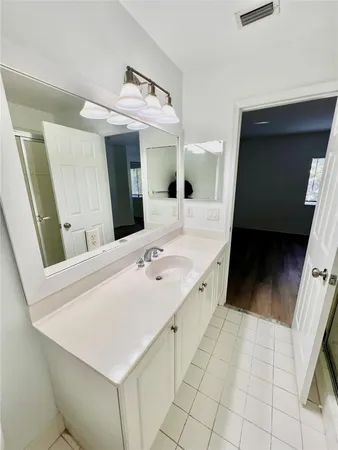 a spacious bathroom with a sink a mirror and bathtub