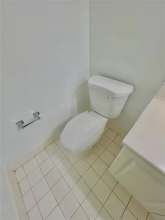 a bathroom with a toilet and a rug