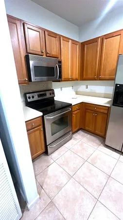 a kitchen with granite countertop a stove a sink and a microwave