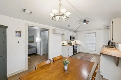 a kitchen with stainless steel appliances granite countertop a sink a stove and refrigerator