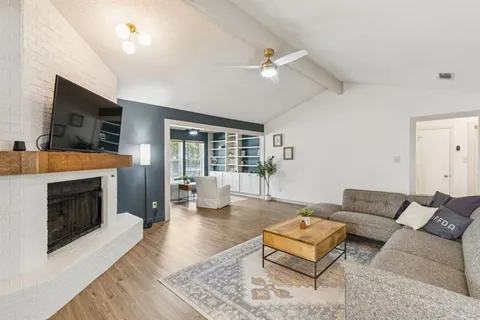 a living room with furniture flat screen tv and a fireplace