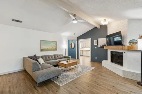 a living room with furniture and a fireplace