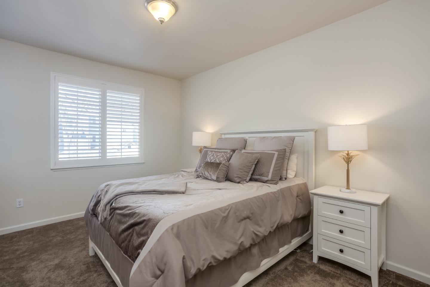 614 Arcadia Terrace, Unit 206 Sunnyvale, CA 94085 - Photo 15 of 21 a bedroom with a bed and a night stand