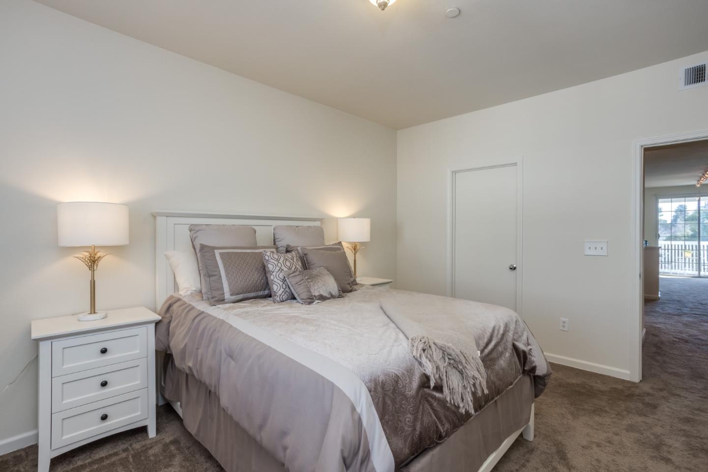 614 Arcadia Terrace, Unit 206 Sunnyvale, CA 94085 - Photo 16 of 21 a bedroom with a bed and a night stand