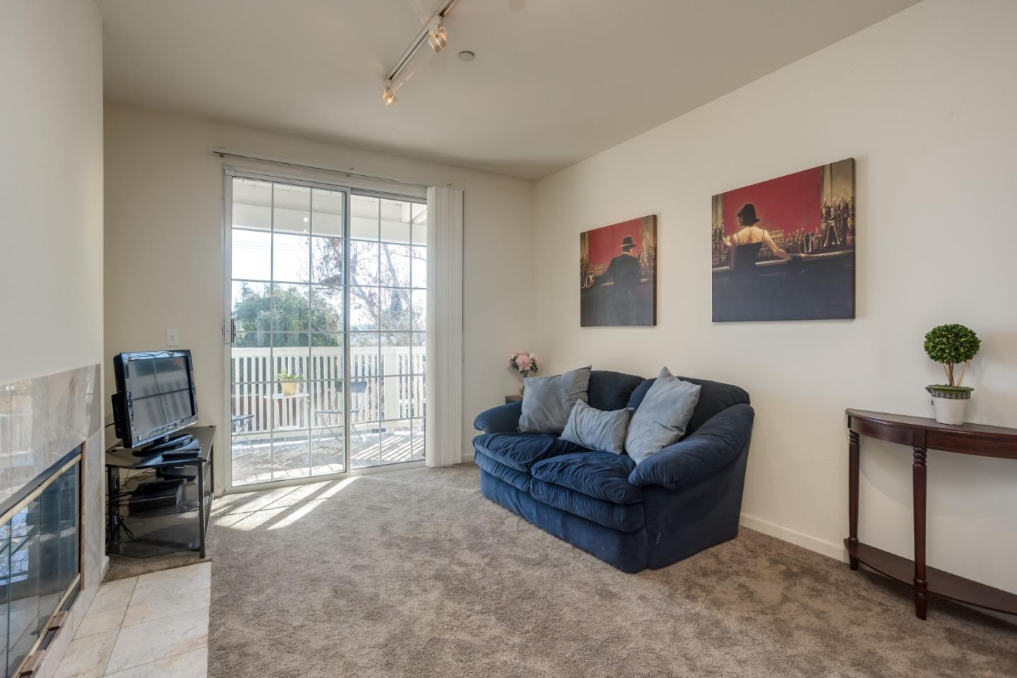 614 Arcadia Terrace, Unit 206 Sunnyvale, CA 94085 - Photo 2 of 21 a living room with furniture and a flat screen tv