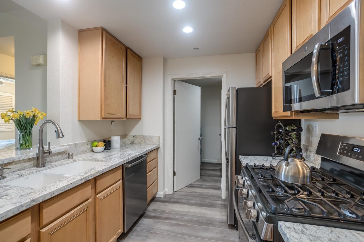 614 Arcadia Terrace, Unit 206 Sunnyvale, CA 94085 - Photo 7 of 21 a kitchen with stainless steel appliances granite countertop a sink stove and refrigerator