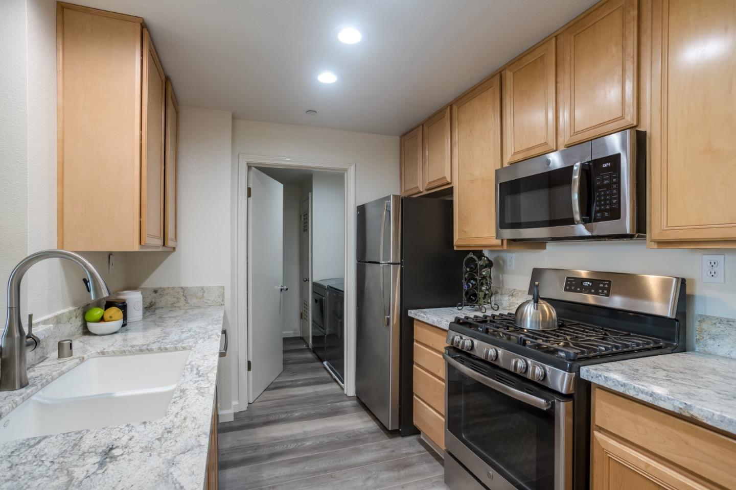 614 Arcadia Terrace, Unit 206 Sunnyvale, CA 94085 - Photo 8 of 21 a kitchen with stainless steel appliances granite countertop a stove refrigerator and microwave
