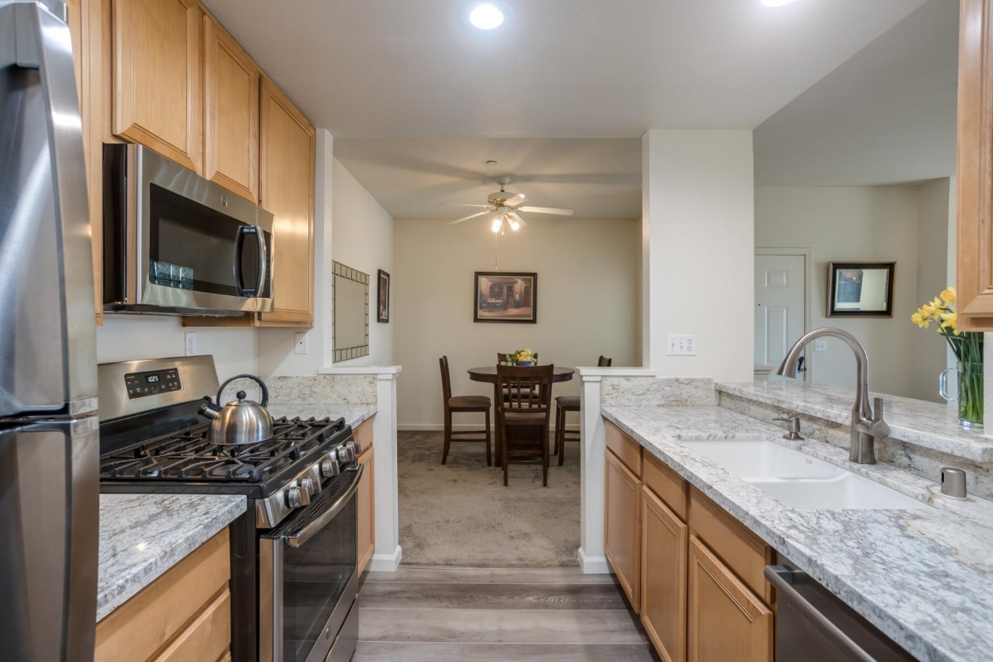 614 Arcadia Terrace, Unit 206 Sunnyvale, CA 94085 - Photo 9 of 21 a kitchen with granite countertop a sink and stove top oven