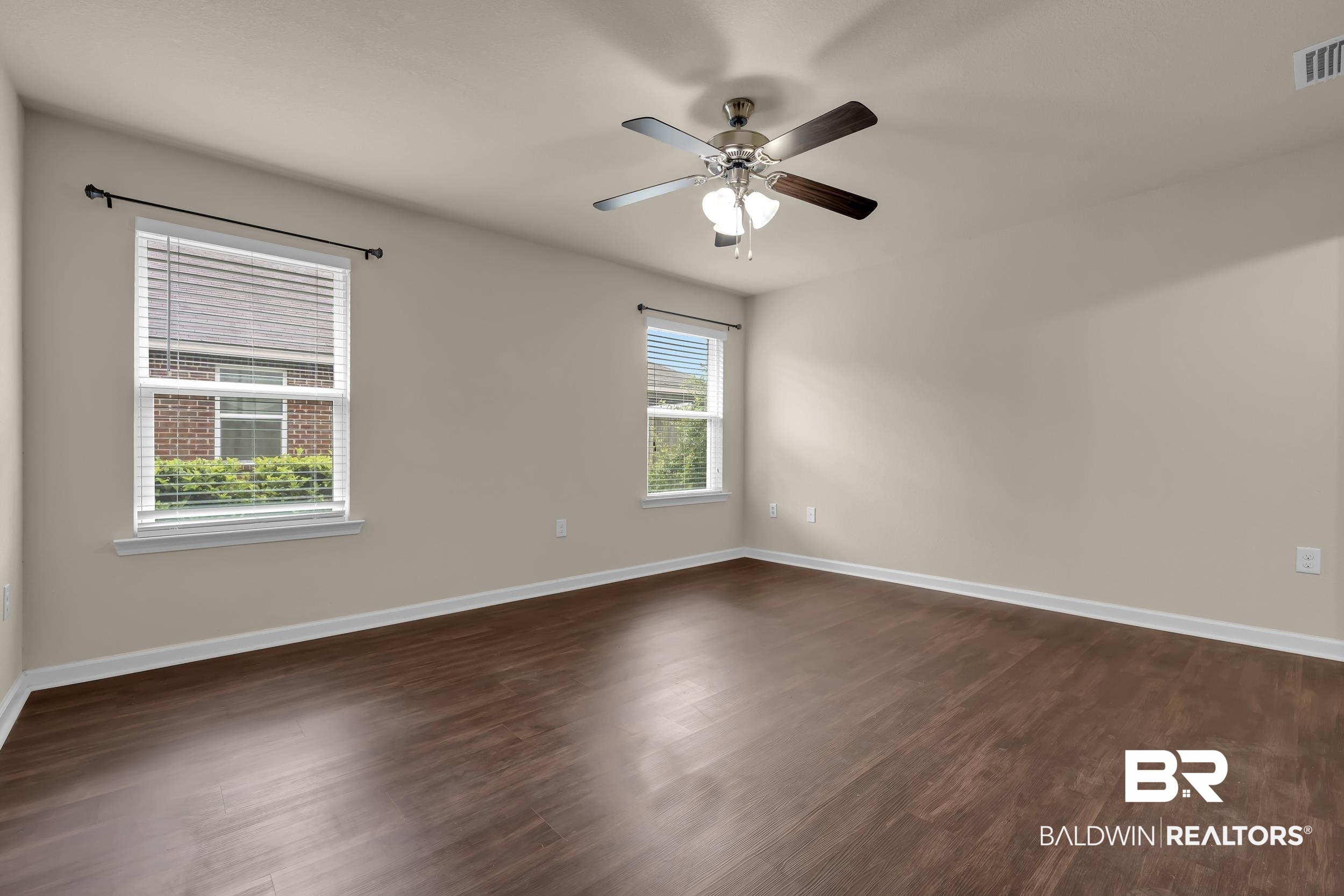 1704 Abbey Loop Foley, AL 36535 - Photo 18 of 38 Spacious room featuring wood-finish flooring, neutral-toned walls, and white baseboards