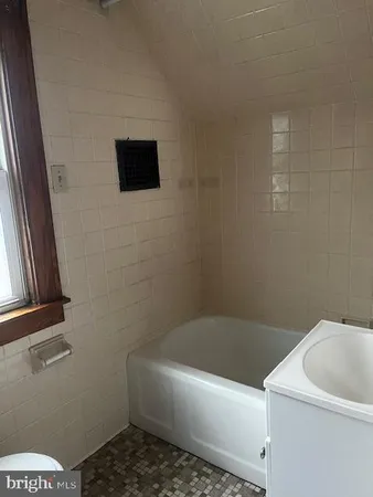 a bathroom with a bathtub and toilet