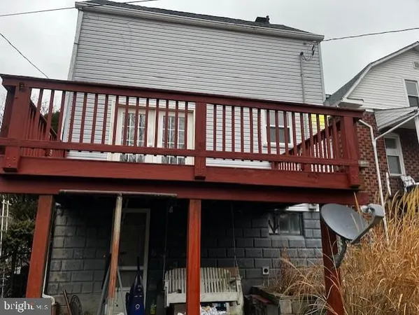 a view of a house with a wooden deck