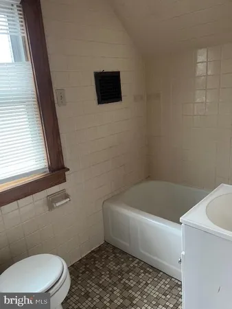 a bathroom with a toilet a sink and bathtub