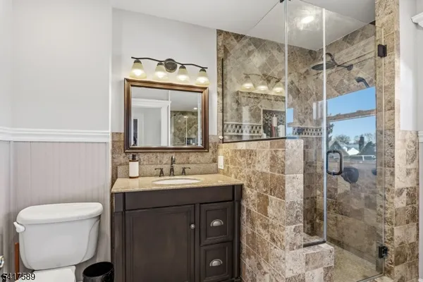 a bathroom with a sink mirror and toilet