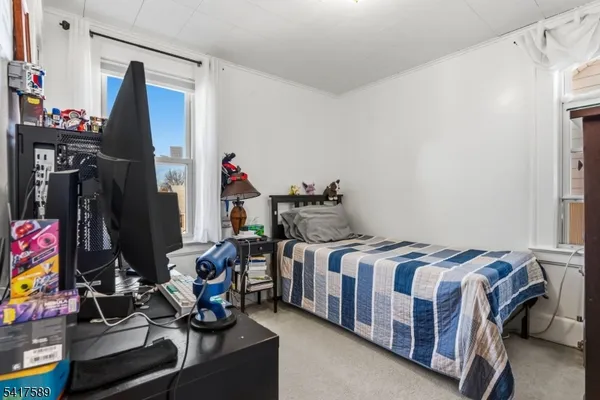 a bedroom with two beds and a closet