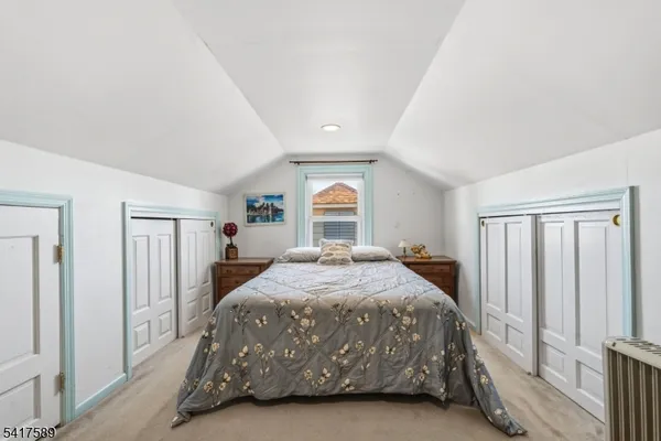 a bedroom with a bed next to a window