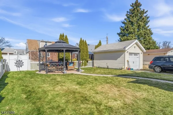a view of a house with a yard and sitting area