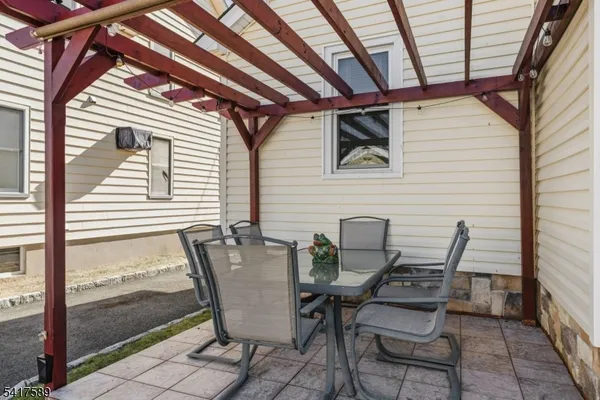 a view of patio with couple of chairs
