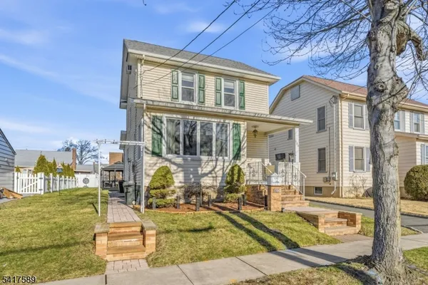 a picture of a open kitchen with a white wall and a white refrigerator