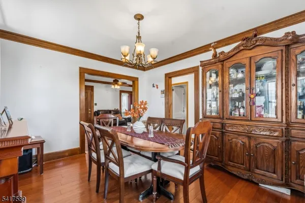 a view of a dining room with furniture wooden floor and chandelier