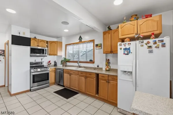 a kitchen with a sink cabinets and stainless steel appliances