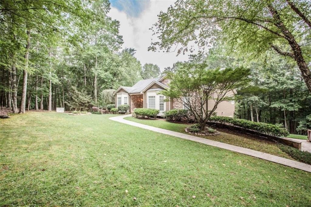 9358 West Banks Mill Road Winston, GA 30187 - Photo 1 of 1 a front view of a house with a yard and garage