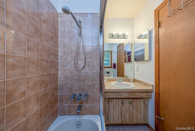 a bathroom with a sink a mirror and shower