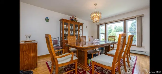 a view of a dining room with furniture wooden floor and chandelier