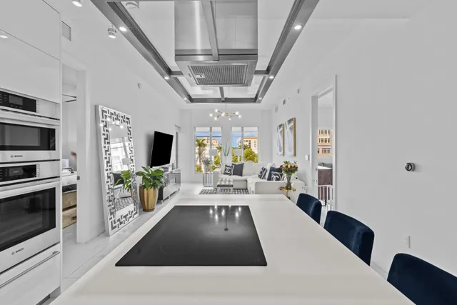 a view of a living room and kitchen with furniture