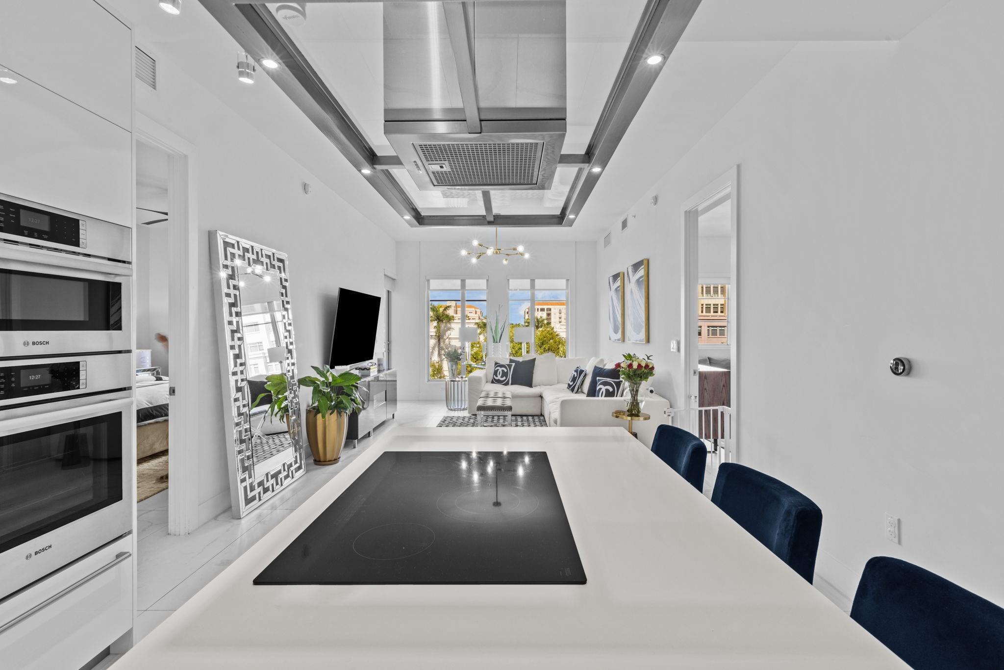 155 East Boca Raton Road, Unit 417 Boca Raton, FL 33432 - Photo 6 of 29 a view of a living room and kitchen with furniture