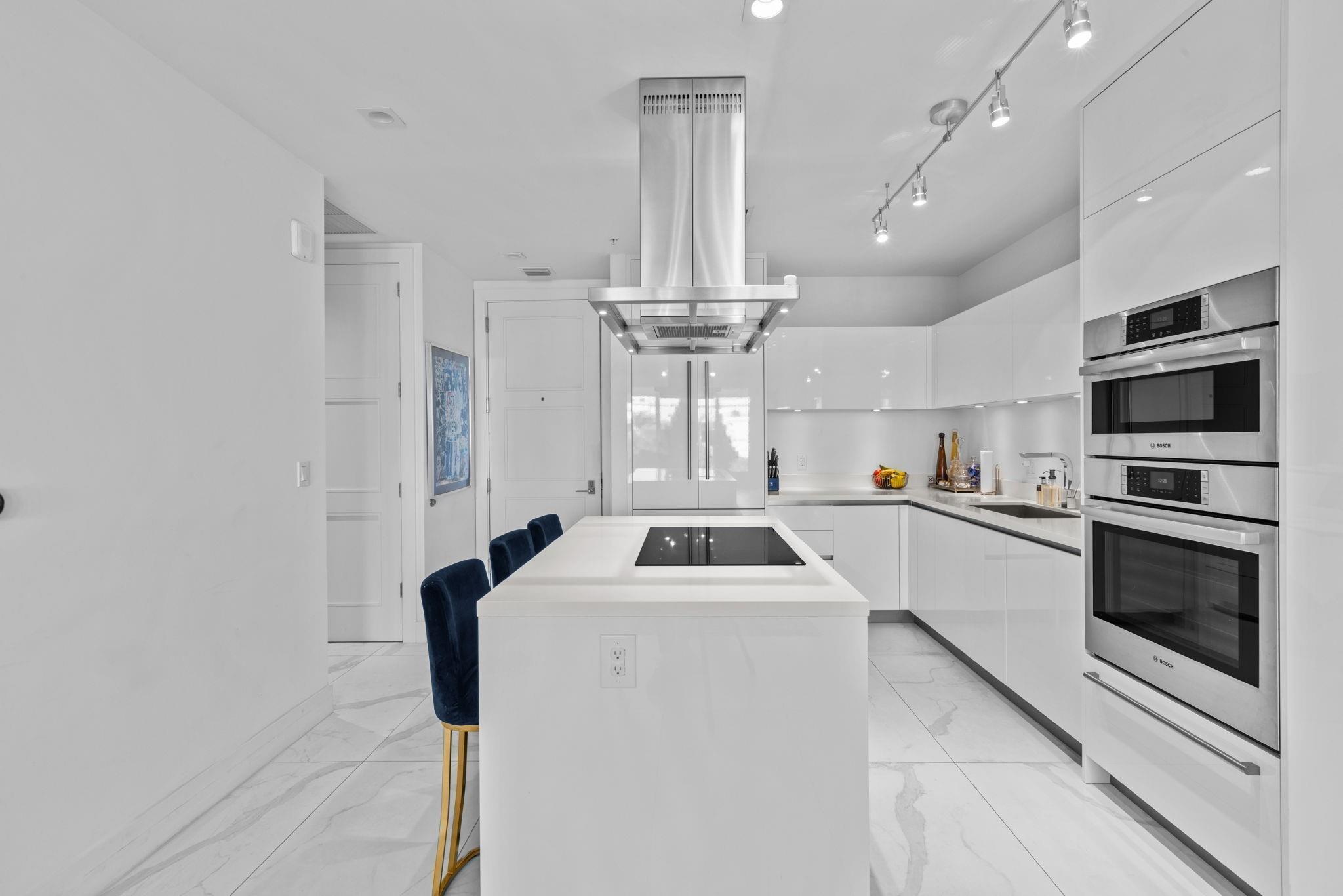 155 East Boca Raton Road, Unit 417 Boca Raton, FL 33432 - Photo 7 of 29 a kitchen with kitchen island a counter top space stainless steel appliances and cabinets