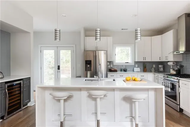 a kitchen with stainless steel appliances a white stove top oven and refrigerator
