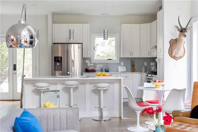a kitchen with stainless steel appliances granite countertop a refrigerator and a stove