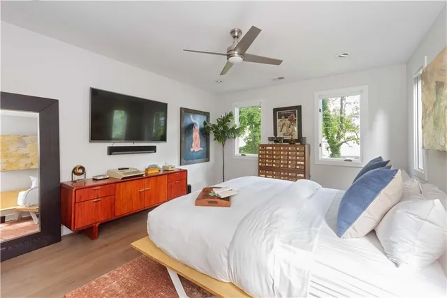 a bedroom with a bed and a flat screen tv