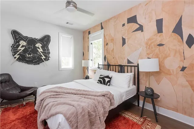 a bedroom with a bed and a painting on the wall