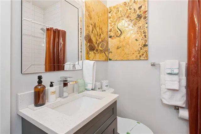 a bathroom with a sink toilet and mirror