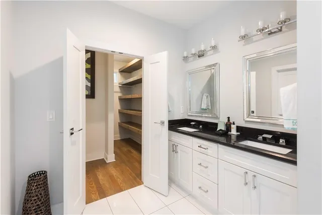 a spacious bathroom with a granite countertop sink and a mirror