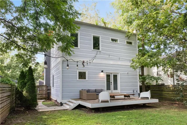 a backyard of a house with yard table and chairs
