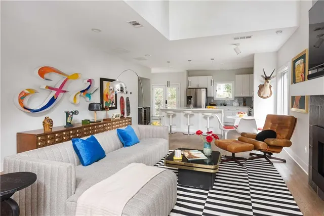 a living room with furniture and kitchen view