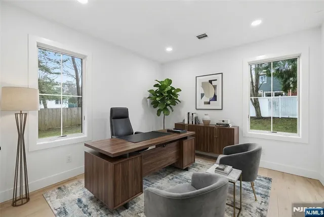 a living room with furniture a window and a potted plant