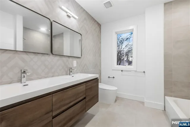 an empty room with wooden floor and furniture