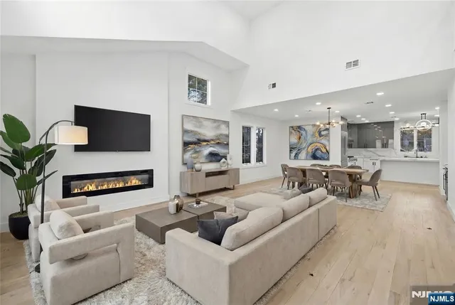 a living room with furniture flat screen tv and a fireplace
