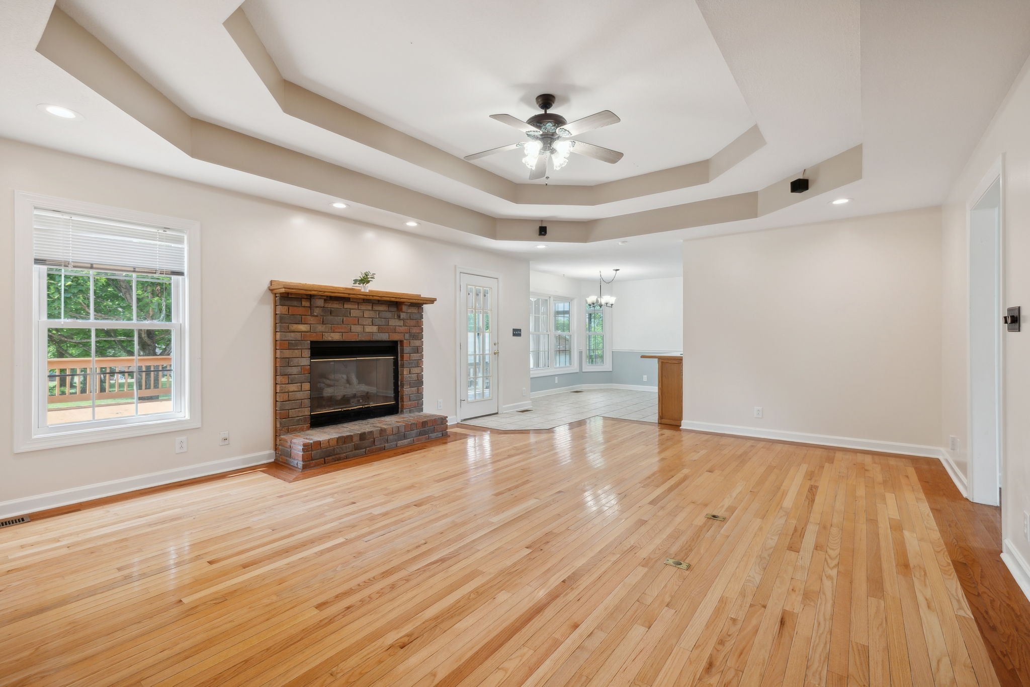 2452 Pleasant View Road Pleasant View, TN 37146 - Photo 10 of 40 Large living room with trey ceiling and exposed brick fire place.